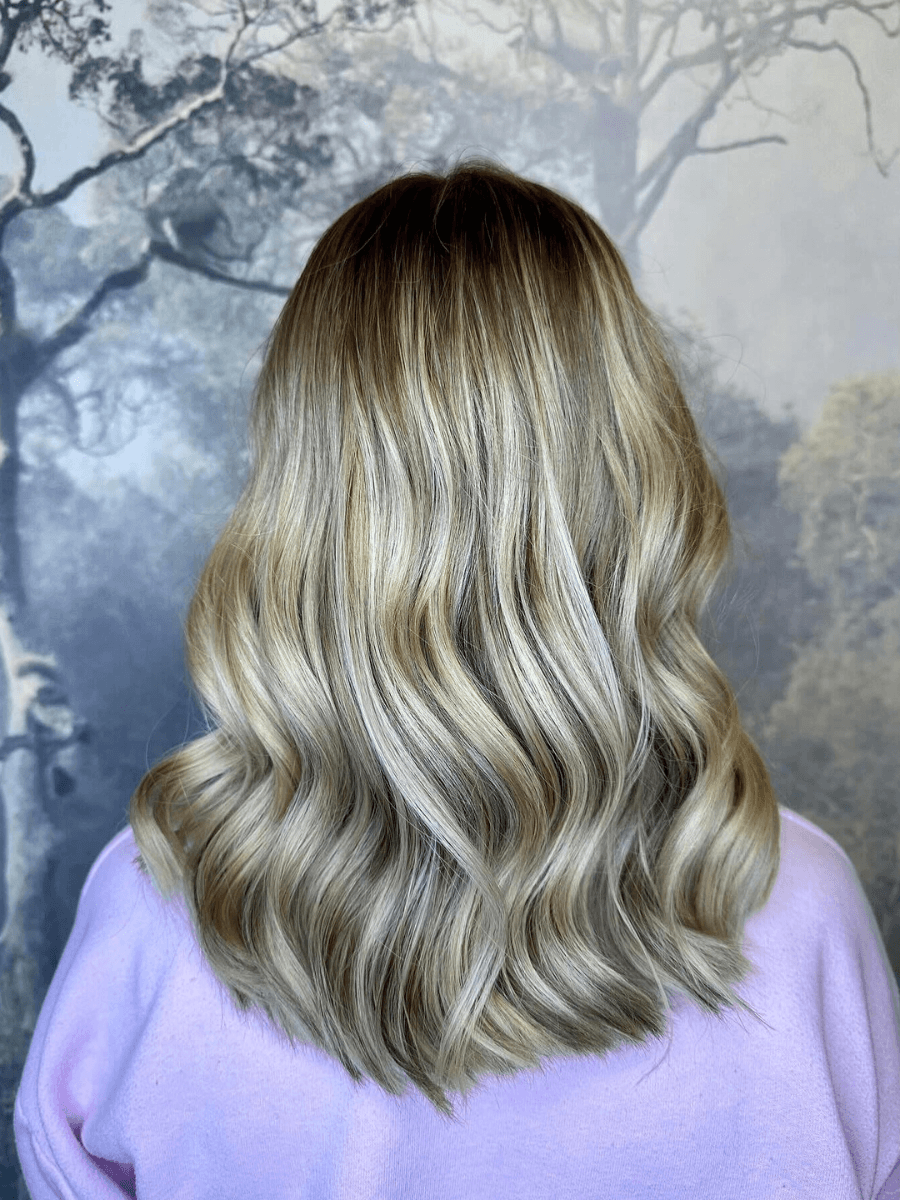 Cool blonde balayage with natural movement and soft waves