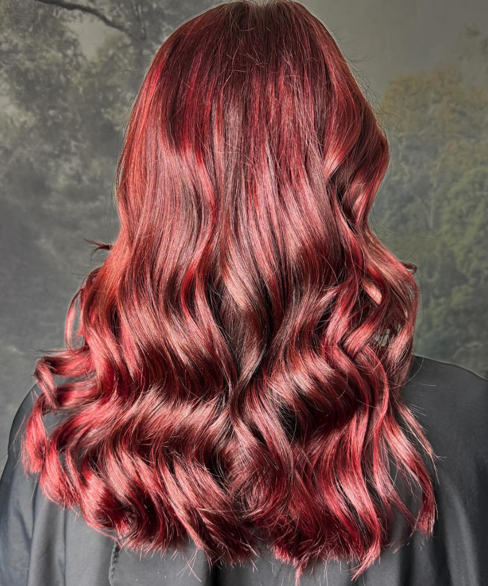 Rich ruby red hair colour with glossy waves created at Verde Hair Lounge