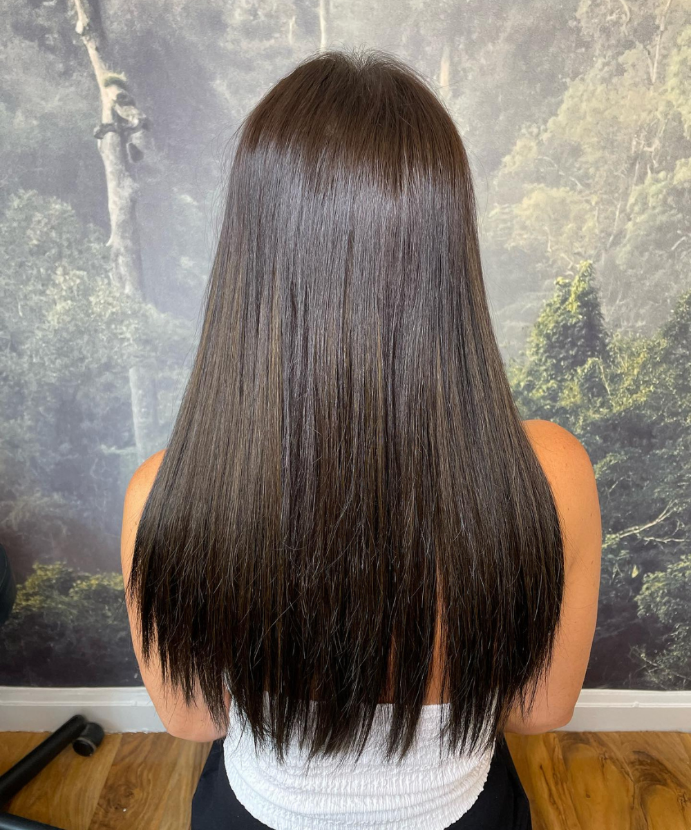 Glossy dark brunette hair with sleek straight finish