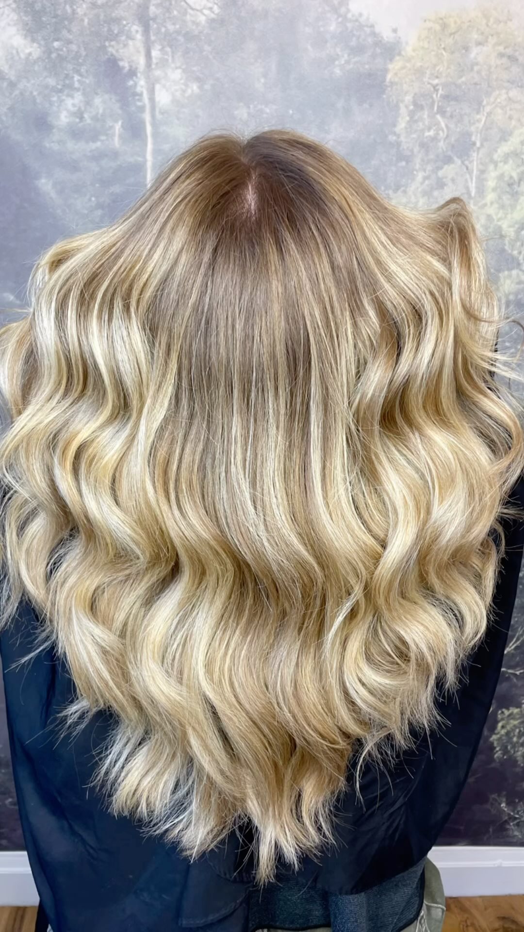 Bright blonde balayage with seamless root melt and soft waves