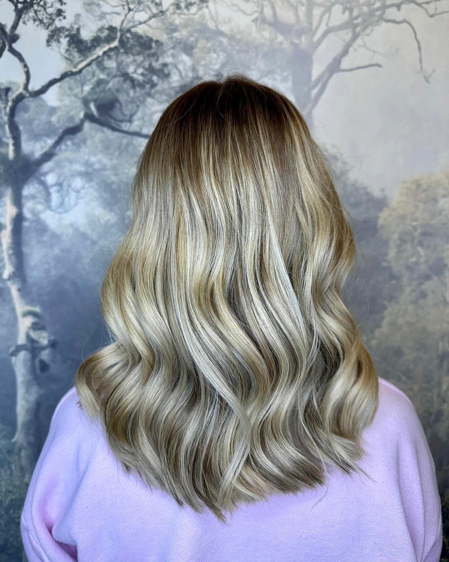 Soft ash blonde balayage with dimensional colour and loose waves