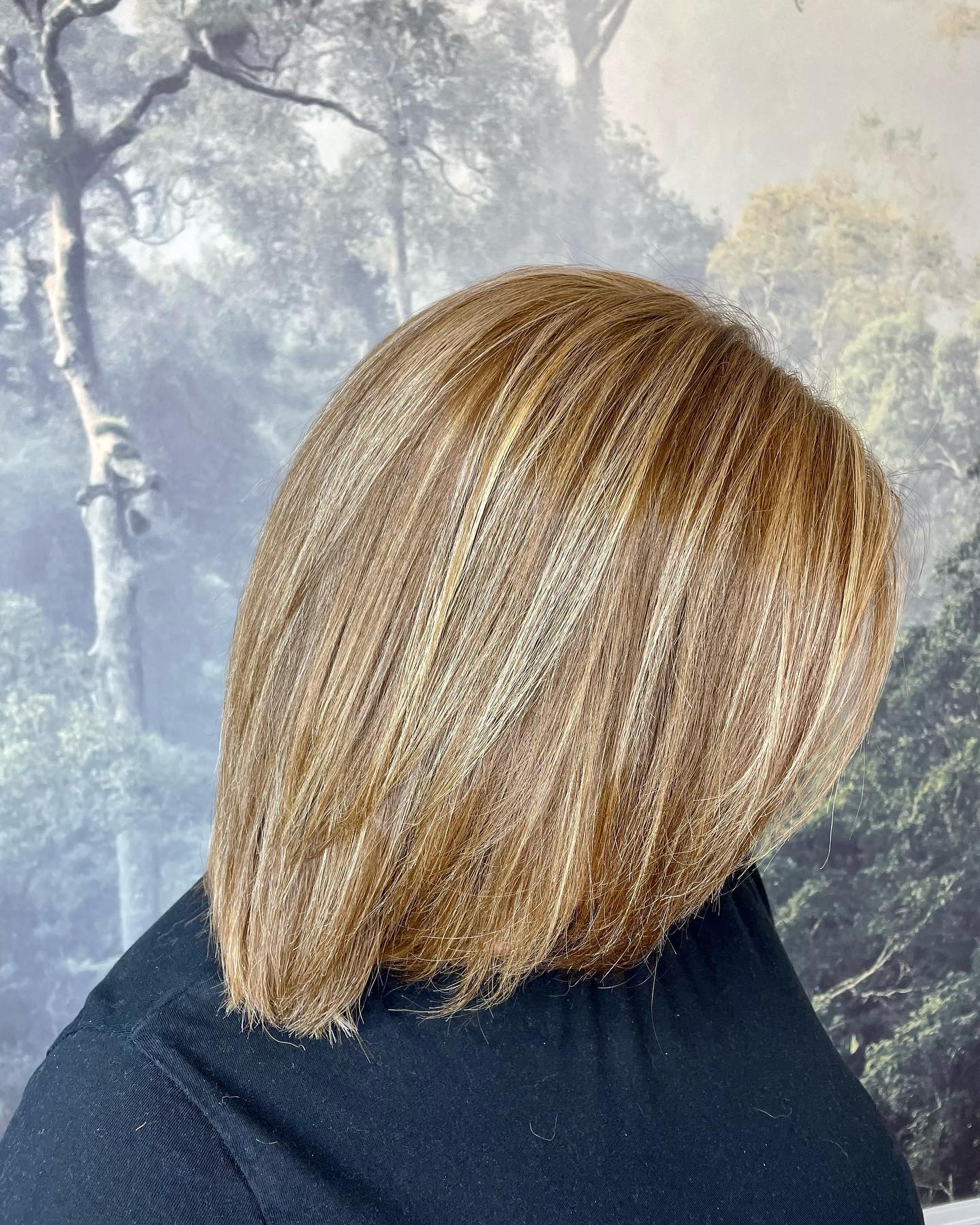 Blonde highlights with sleek layered cut and natural movement