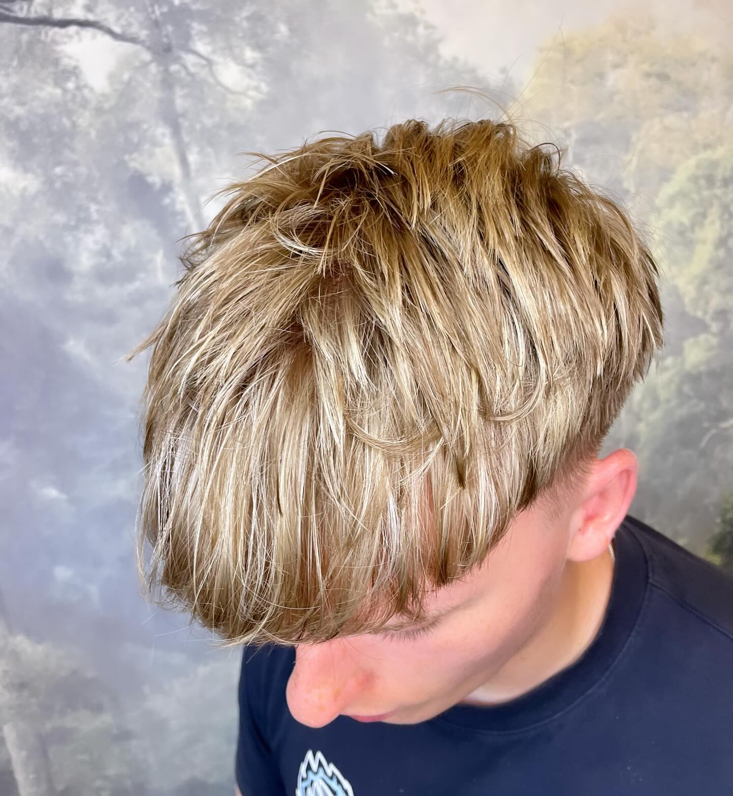 Textured blonde men's haircut with dimensional colour and modern styling