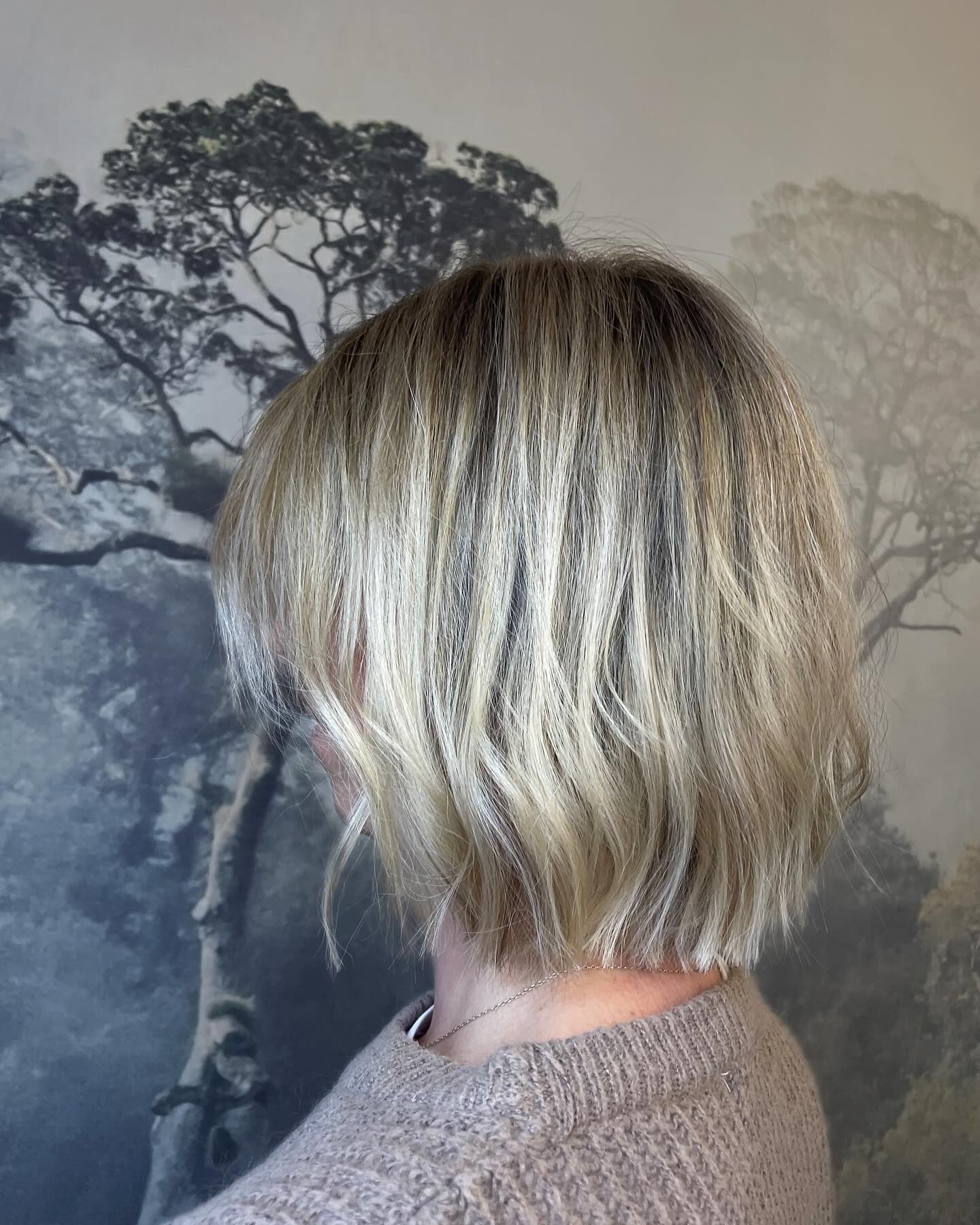 Textured blonde bob with cool-toned balayage and soft waves