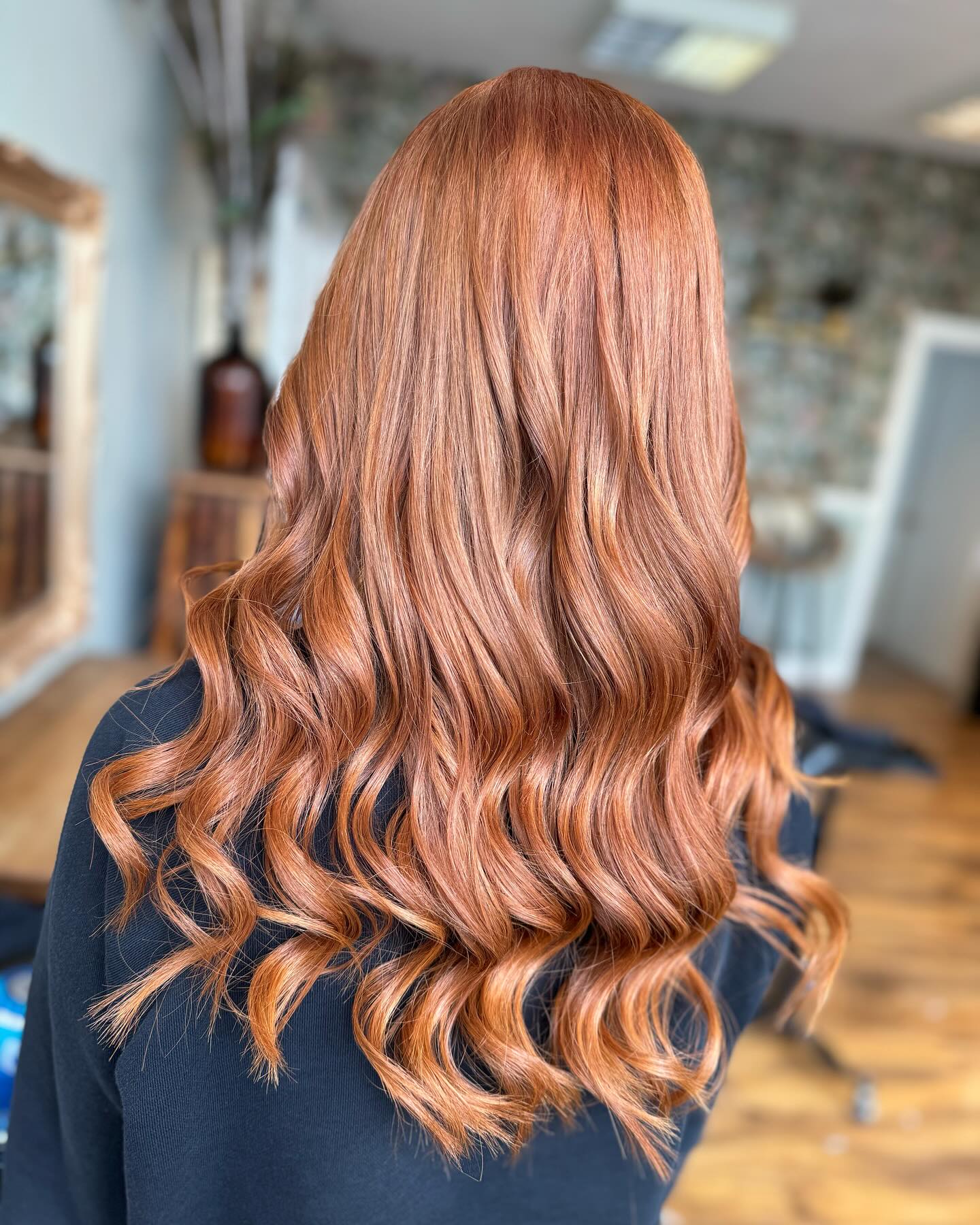 Rich copper hair colour with glossy finish and loose waves