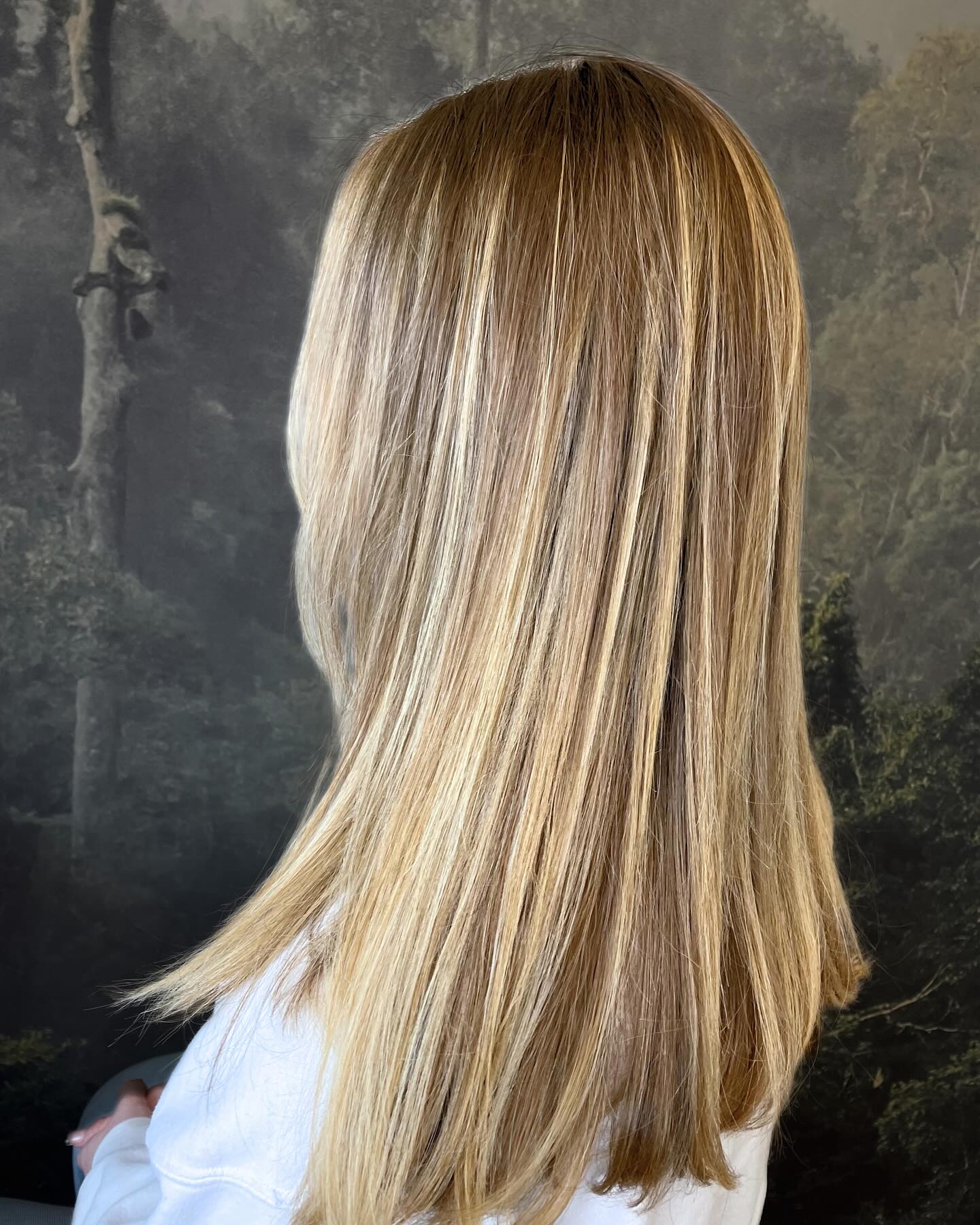 Soft blonde highlights with natural dimension and shoulder-length cut