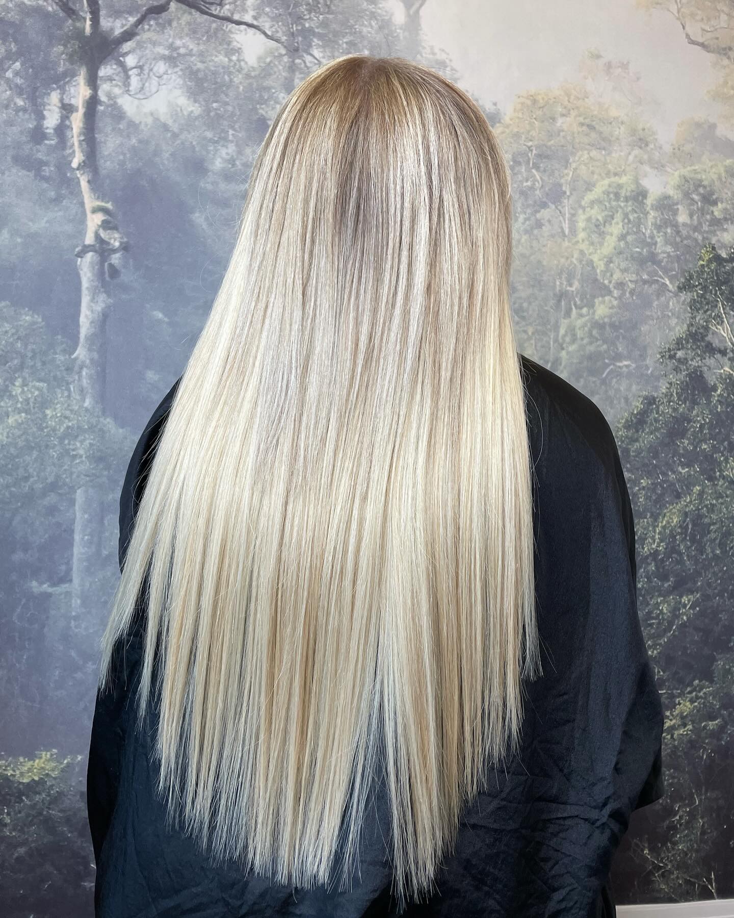Bright platinum blonde hair with sleek finish and high shine