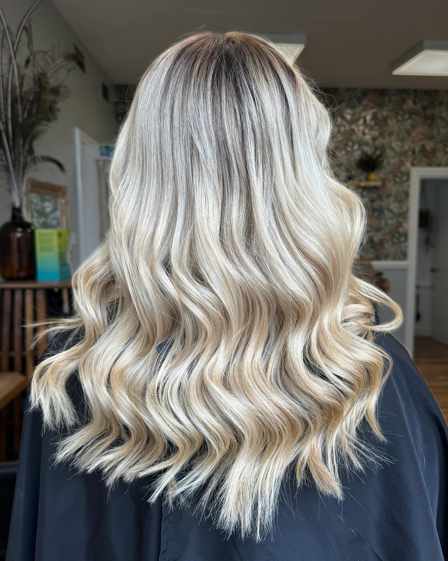 Dimensional blonde balayage with seamless root melt and beach waves