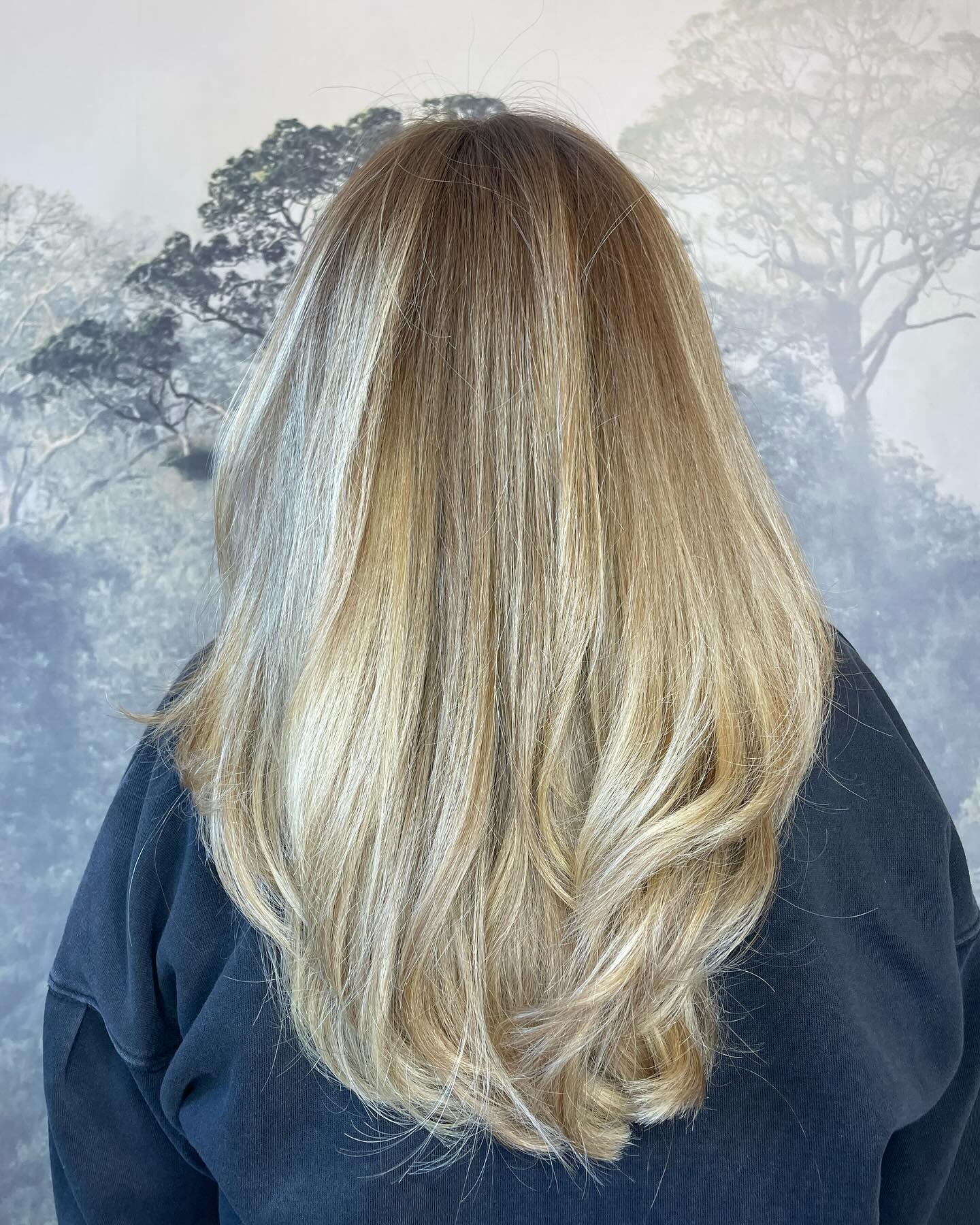 Long blonde hair with layered cut and natural dimension