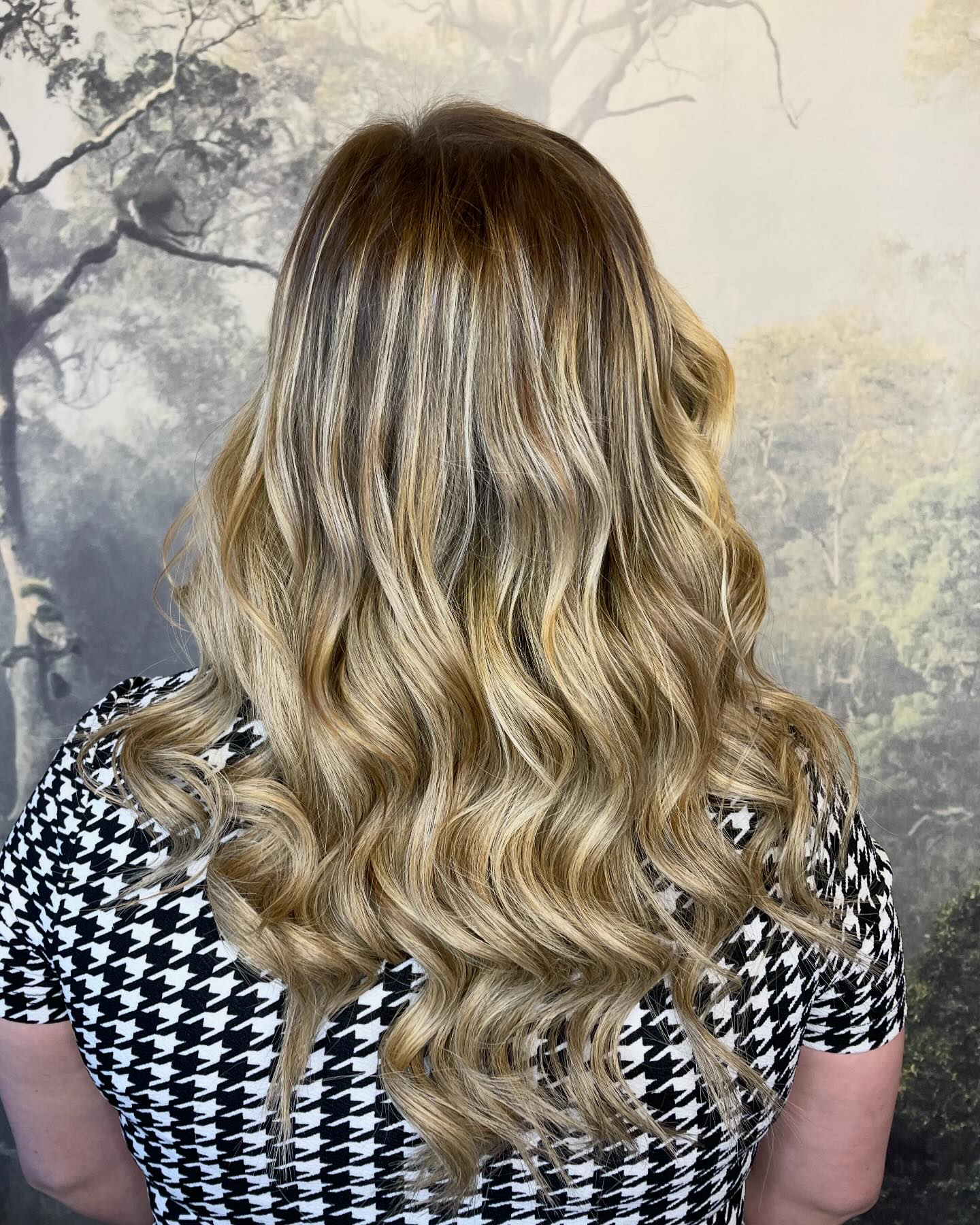 Multi-tonal blonde balayage with depth and soft curls