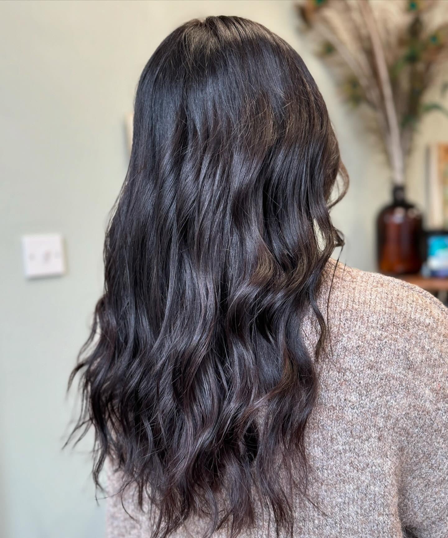 Glossy dark brunette hair with soft natural waves