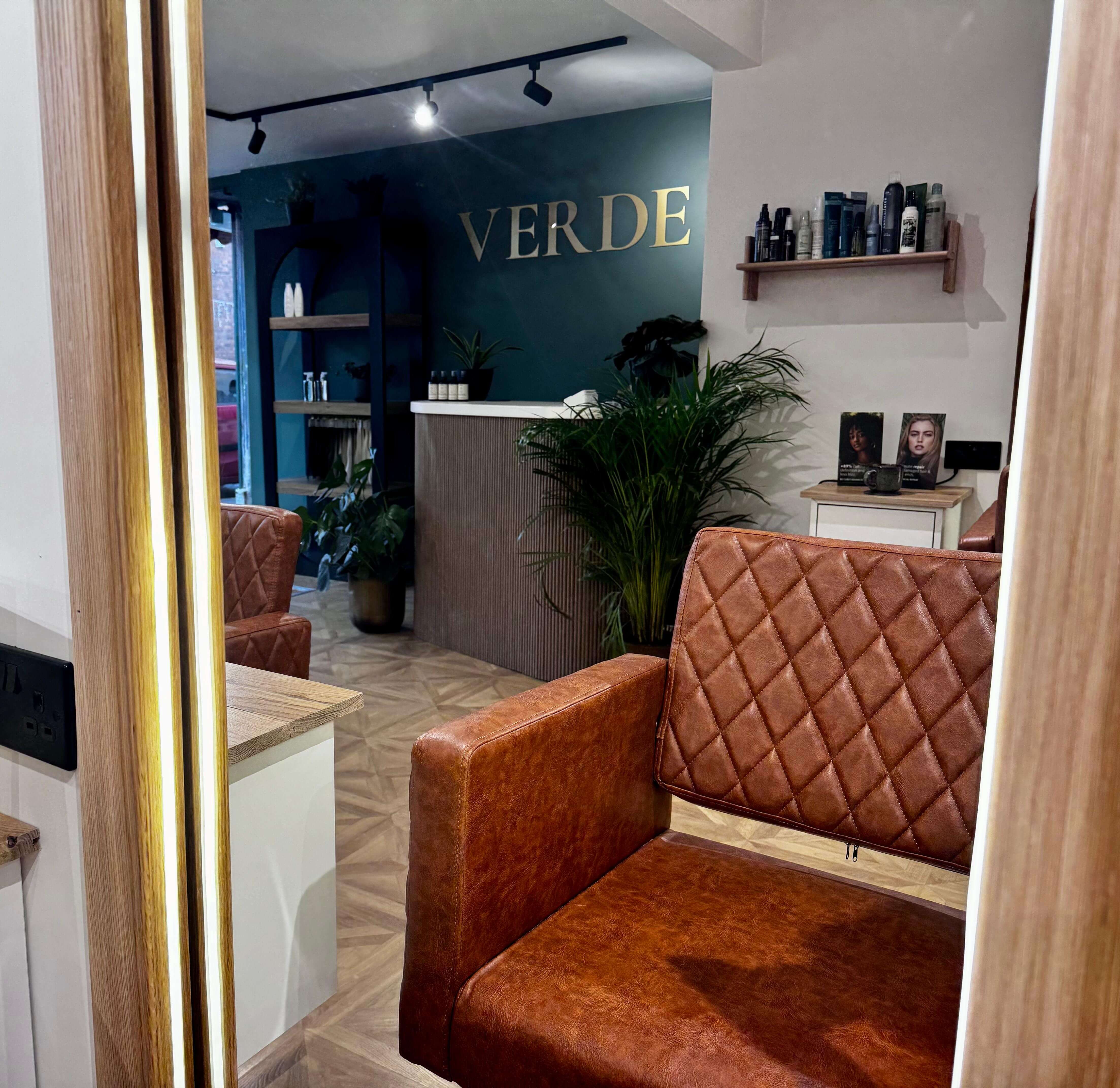 The interior of Verde Hair Lounge reflected in a styling mirror