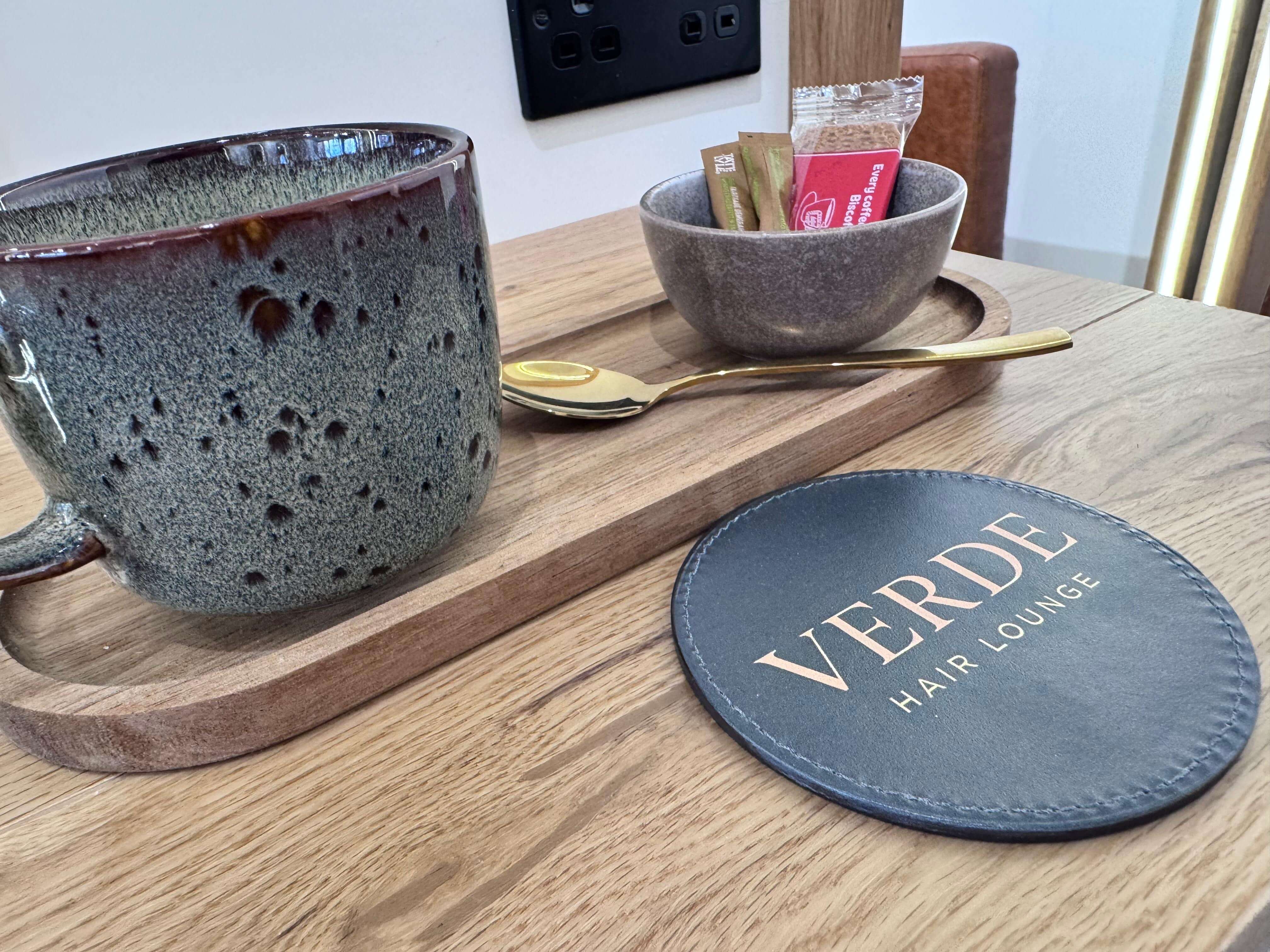 A freshly made coffee served to a guest at Verde Hair Lounge